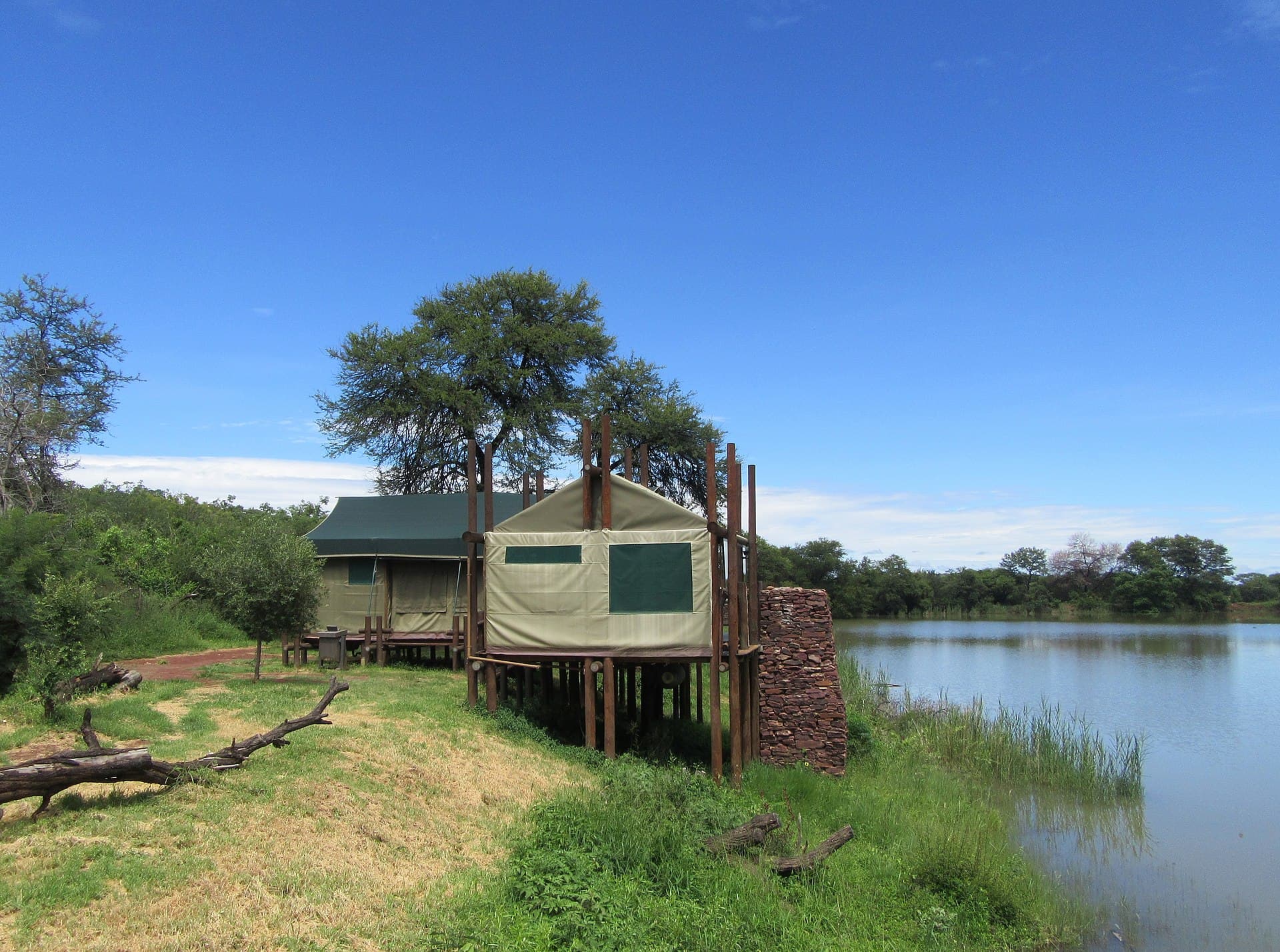 A canvas safari tent set among trees at a private tented camp