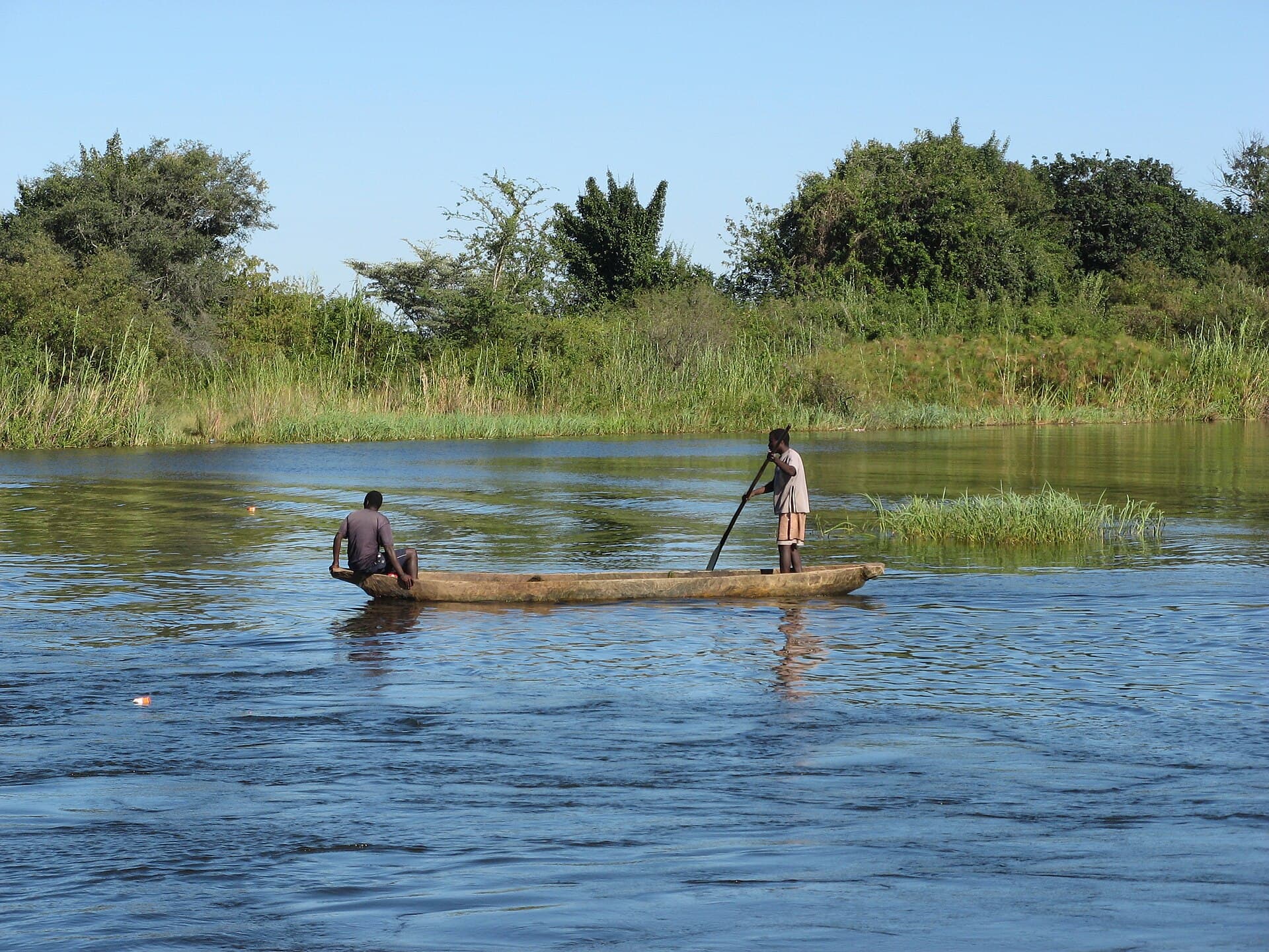 Dugout canoe gliding along the Lower Zambezi